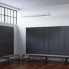 view of space saving slim locker single tier 4 door with seat bench
