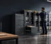 Filing cabinet sizing in action: a facility manager measures a records wall and checks drawer clearance before planning secure file storage